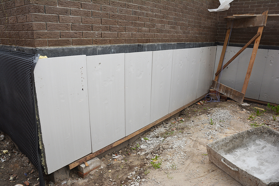 foam boards are installed before applying waterproofing membrane to insulate the exterior foundation wall